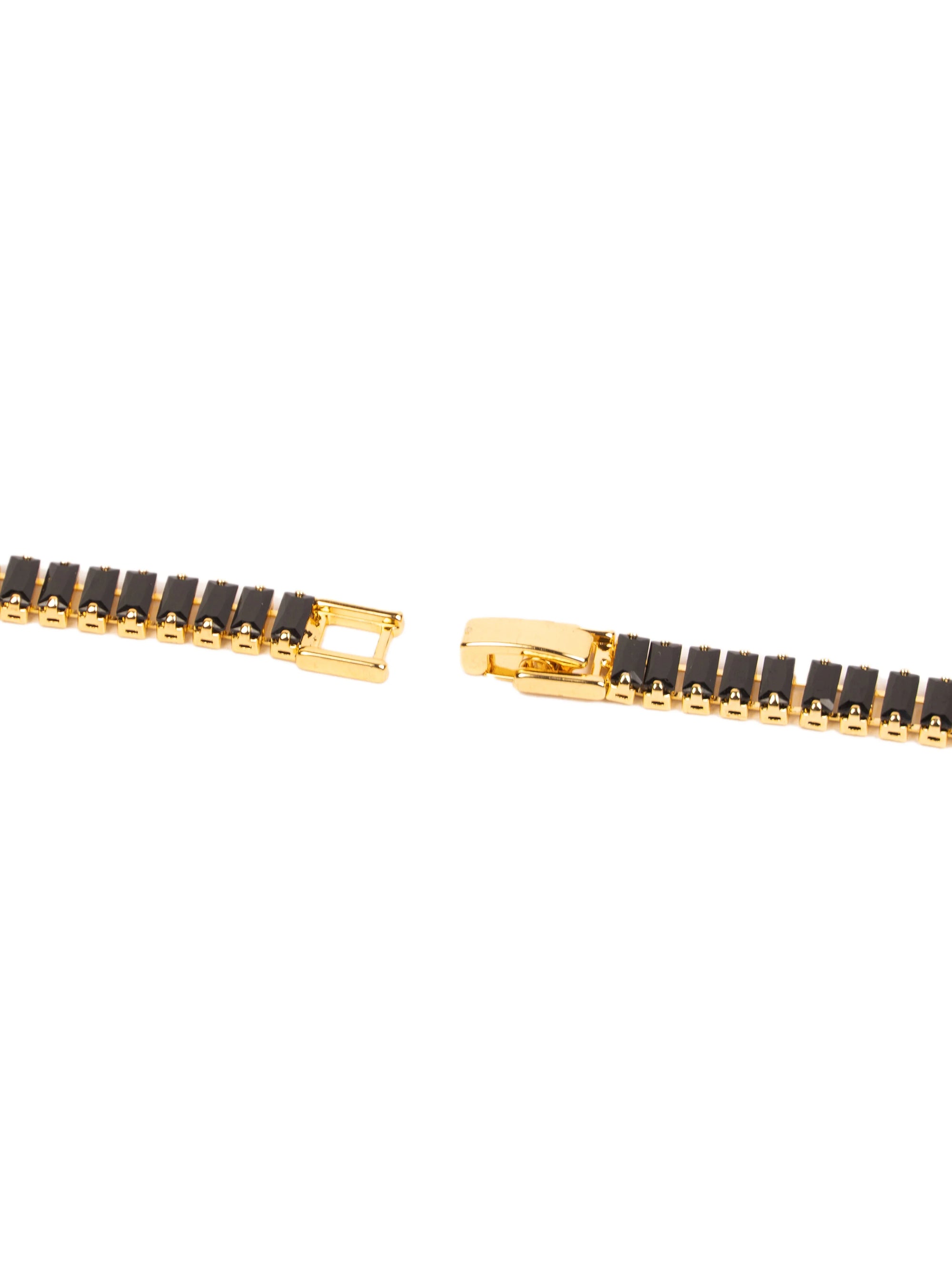 Gold and black bracelet on a white background