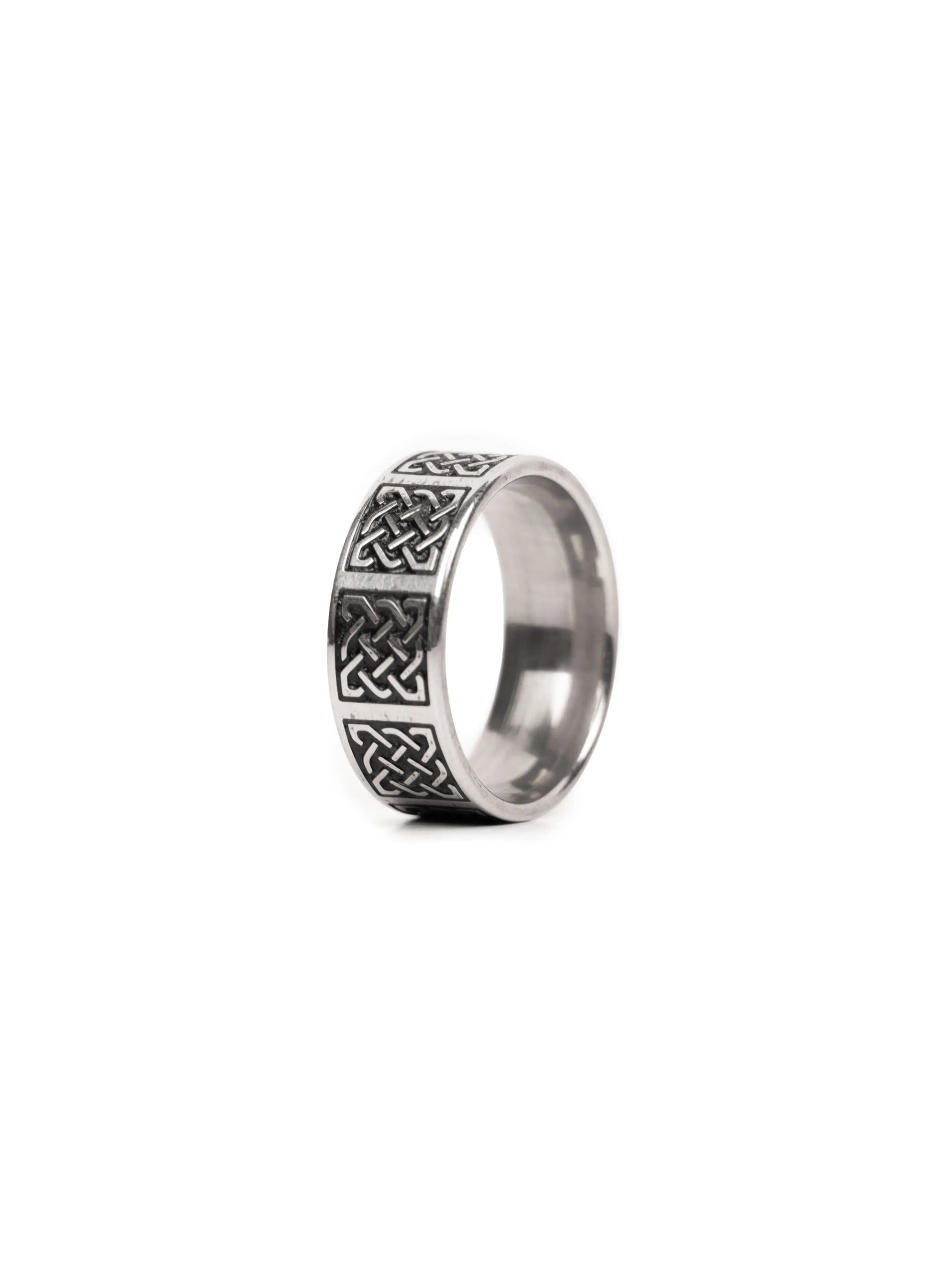 Silver ring with Celtic knot design on a white background