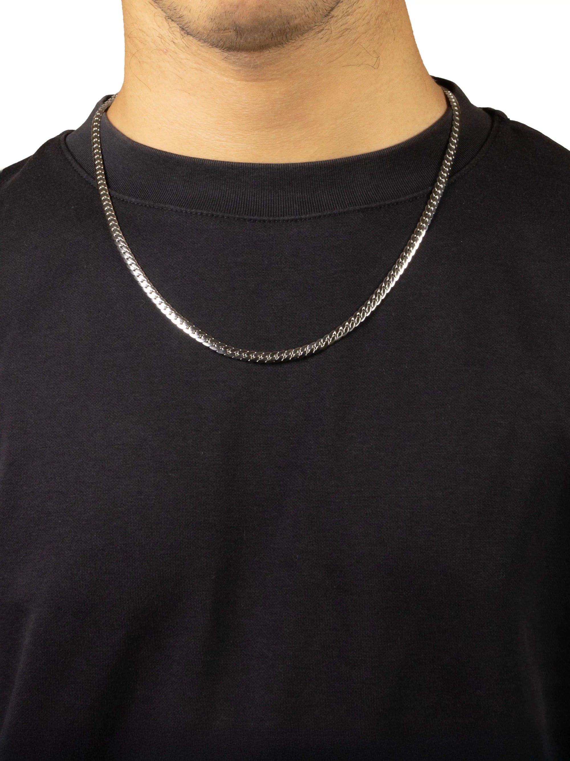 Silver chain necklace on a person wearing a black shirt