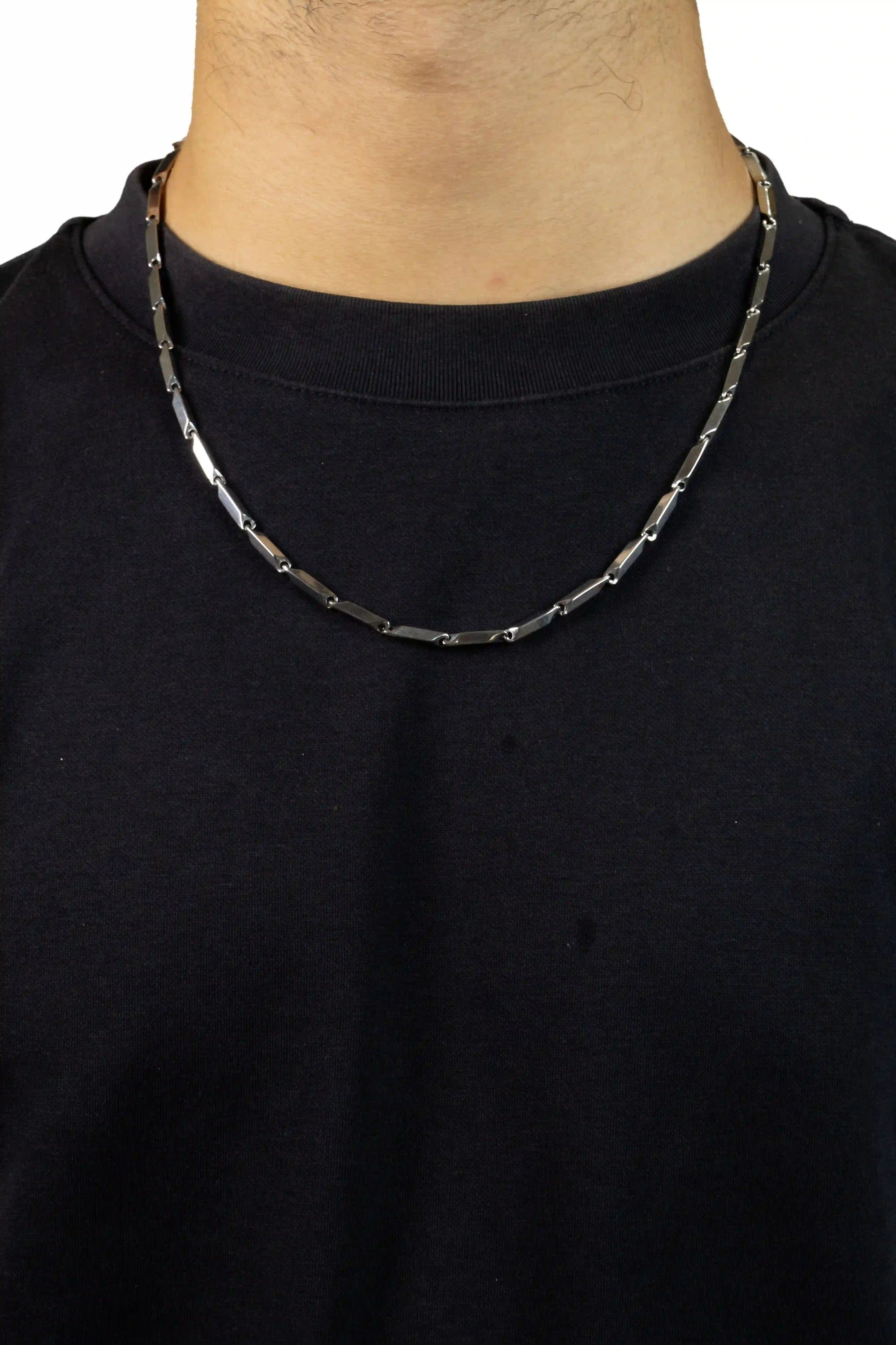 Person wearing a black shirt with a silver chain necklace chrome bladelink