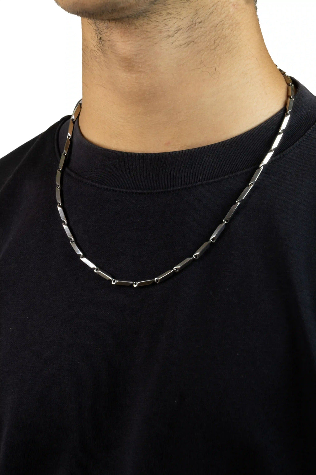 chrome bladelink Person wearing a black shirt with a silver chain necklace