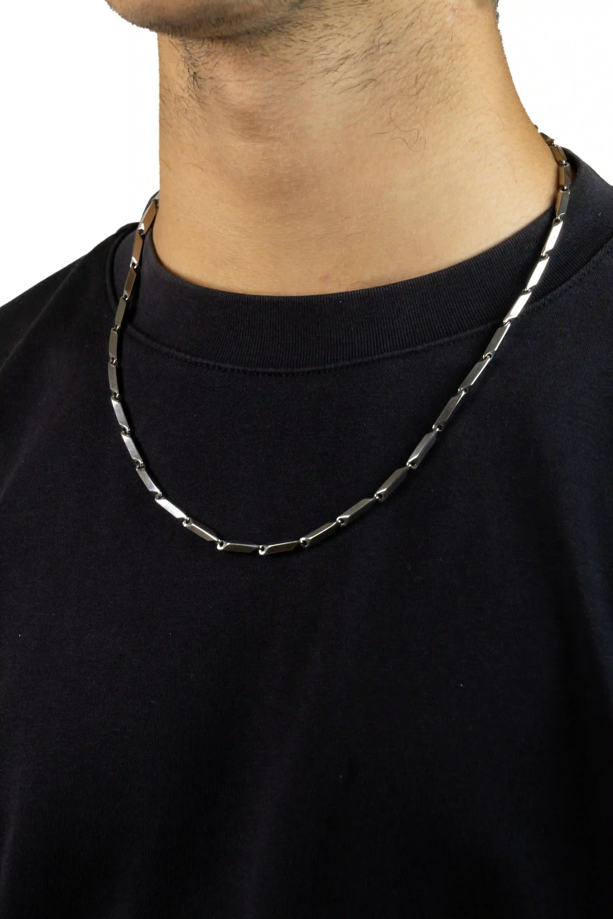 chrome bladelink Person wearing a black shirt with a silver chain necklace