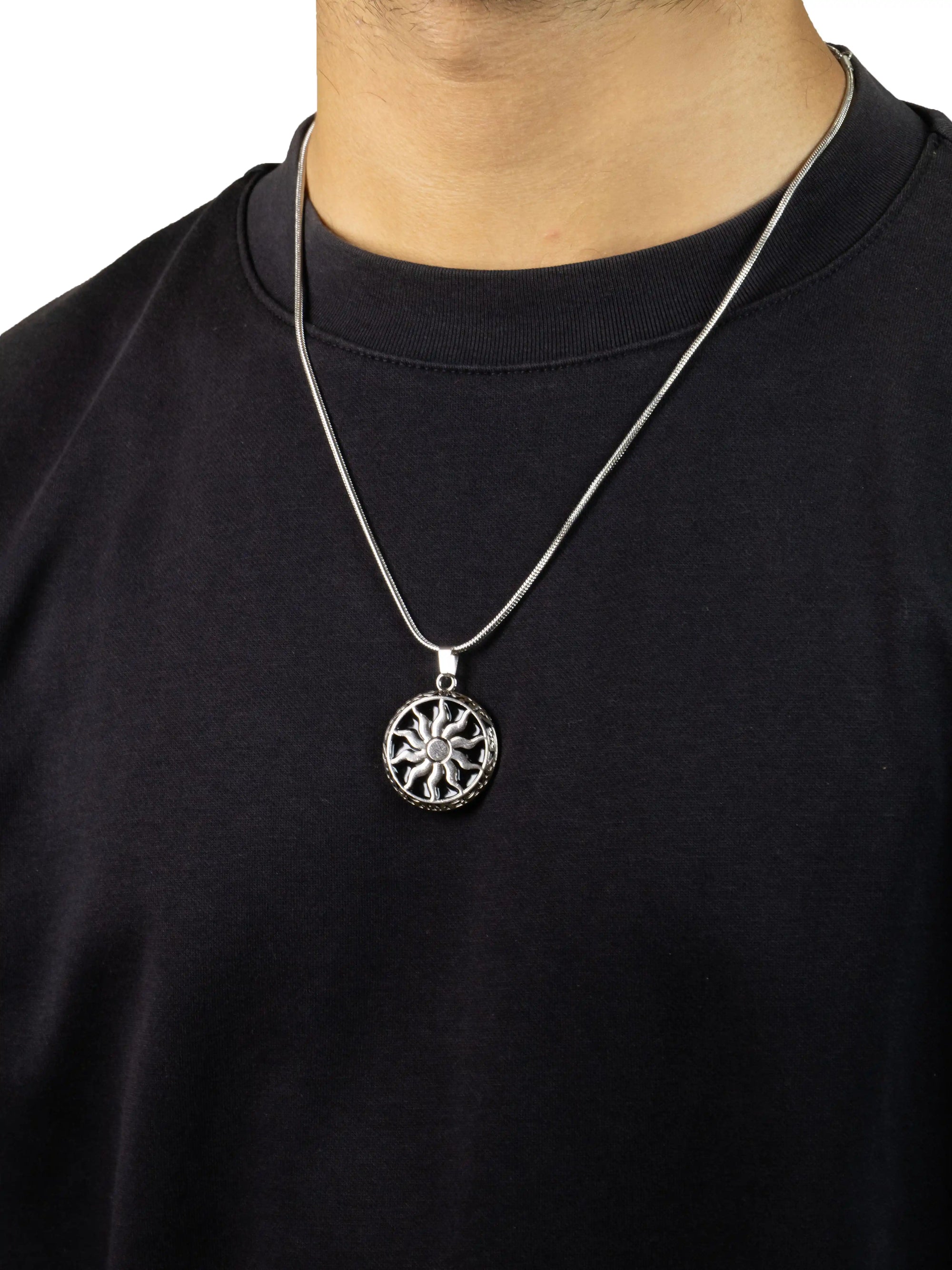 Person wearing a black shirt with a silver necklace featuring a circular pendant. chakra pendent stawp