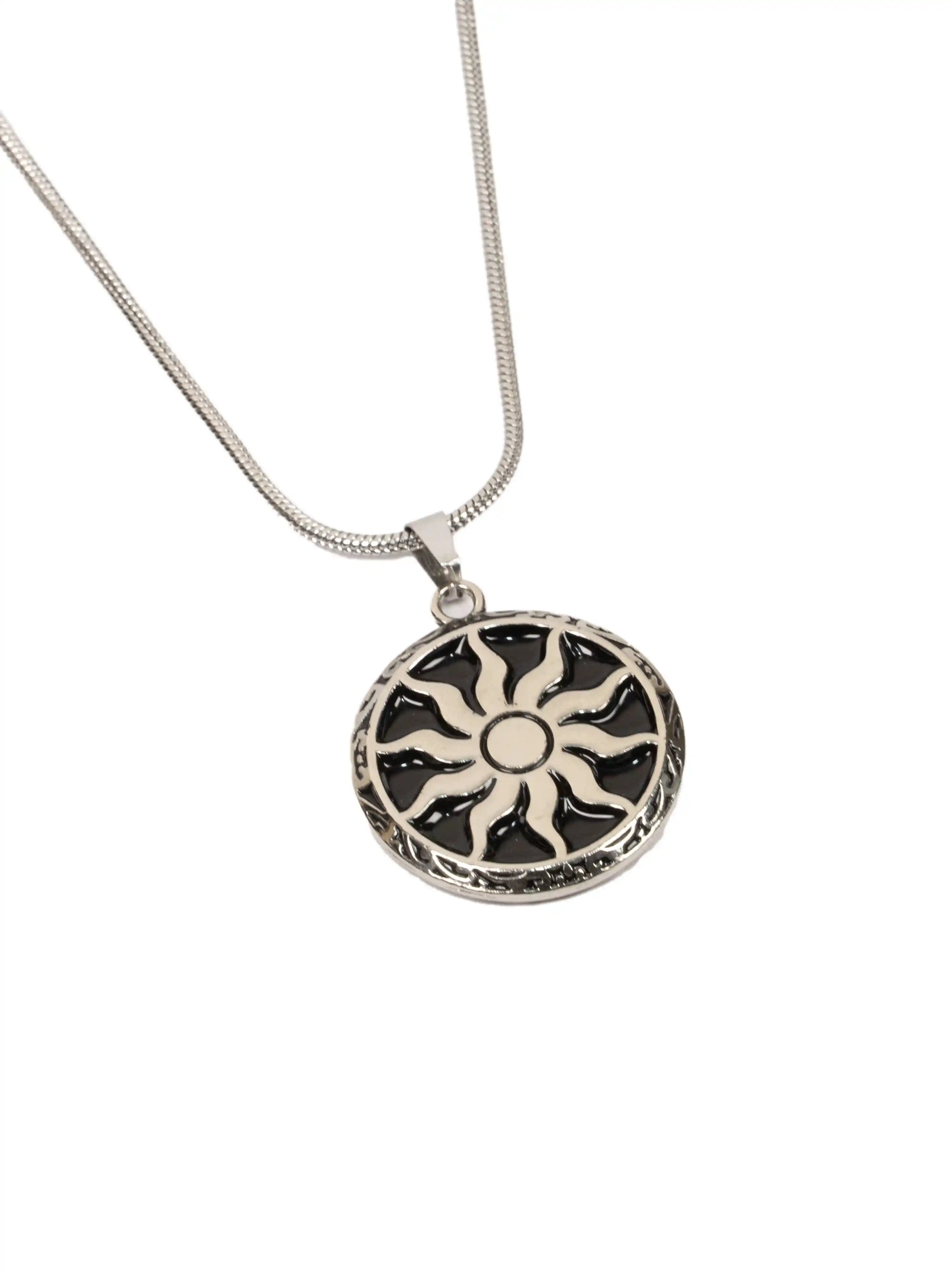 chakra pendent
Silver necklace with a sun-shaped pendant on a white background