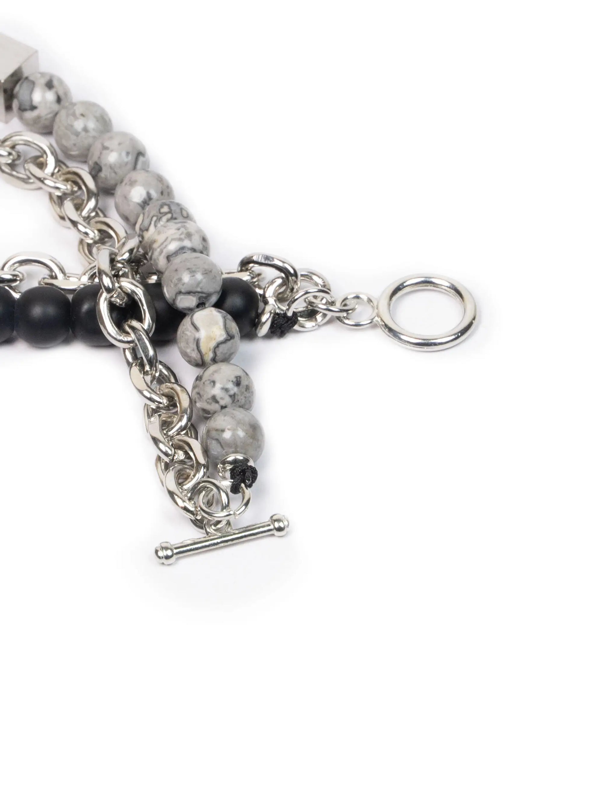 Close-up of a bracelet with beads and chain on a white background