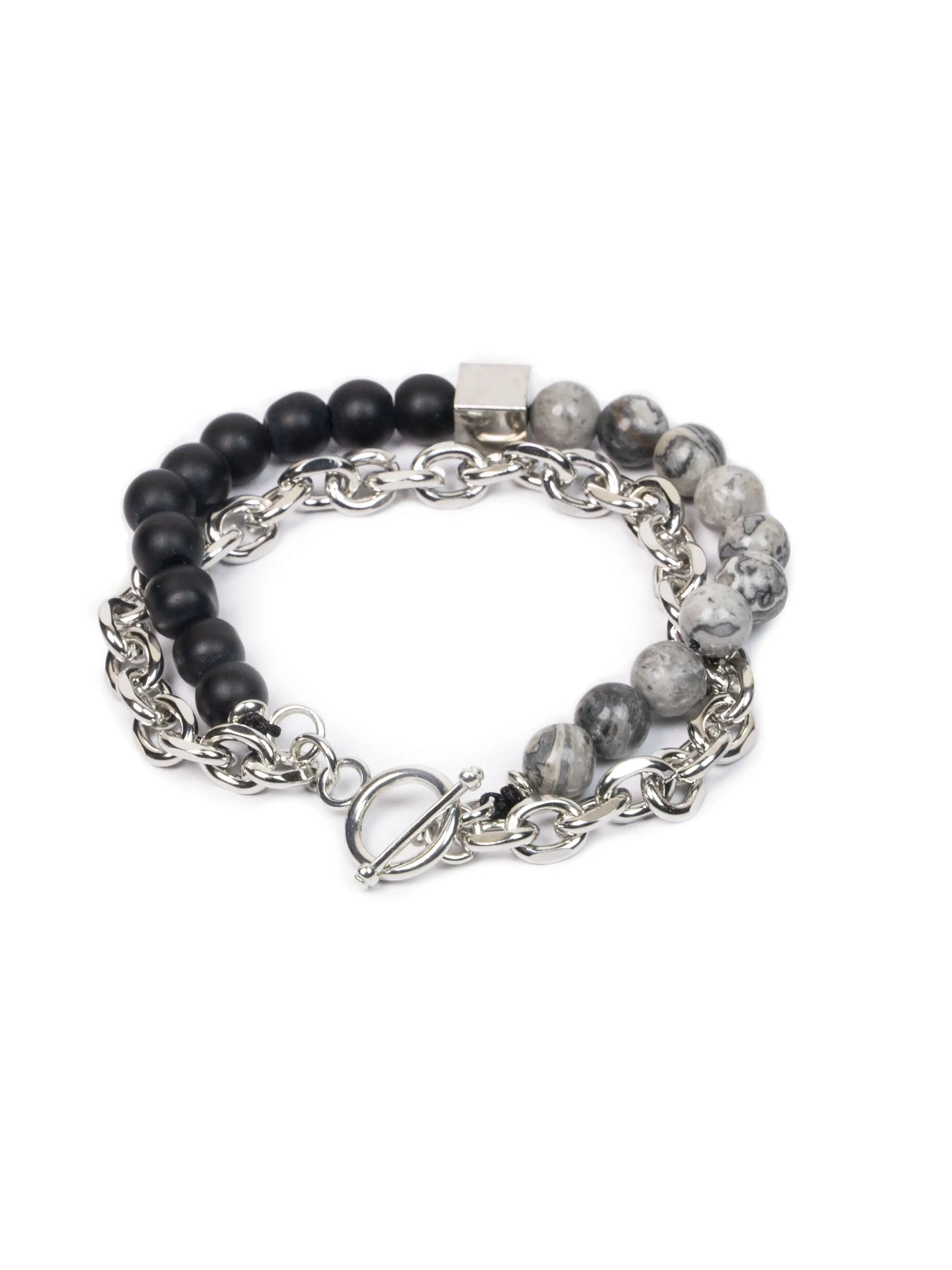 Bracelet with black and gray beaded sections and silver chain on a white background