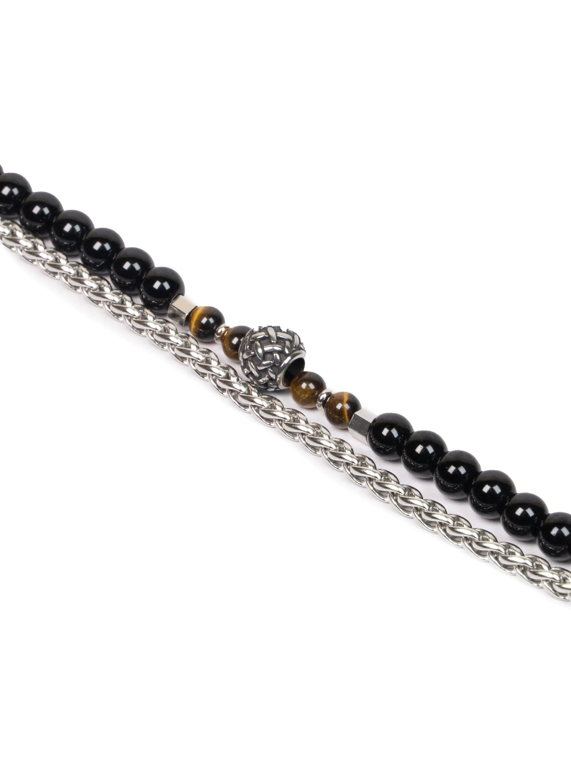 Necklace with black beads and a silver chain on a white background