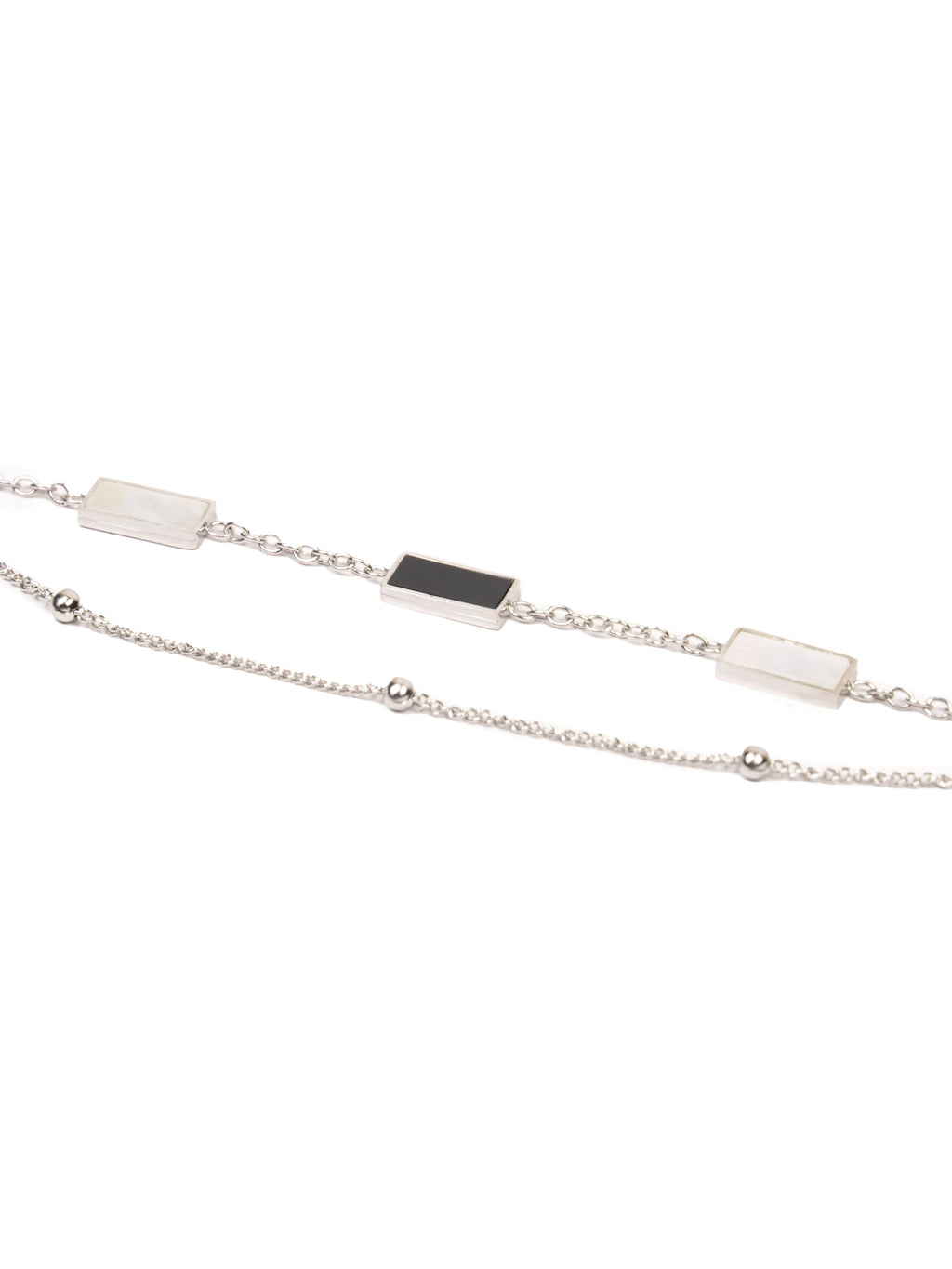 Silver necklace with black and white stone pendants on a white background