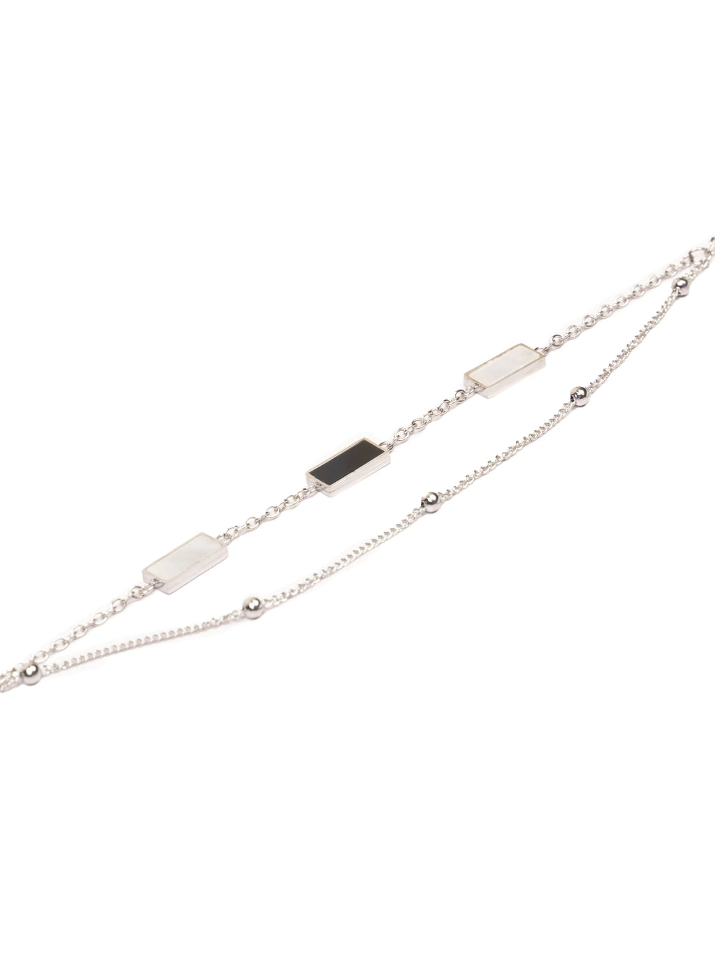 Silver bracelet with black and white stones on a white background