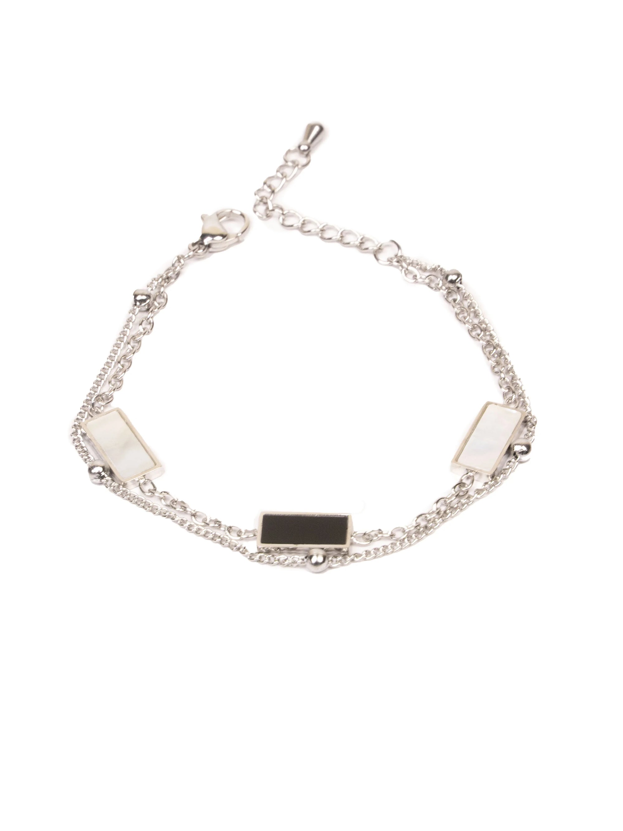 Silver bracelet with black and white stones on a white background