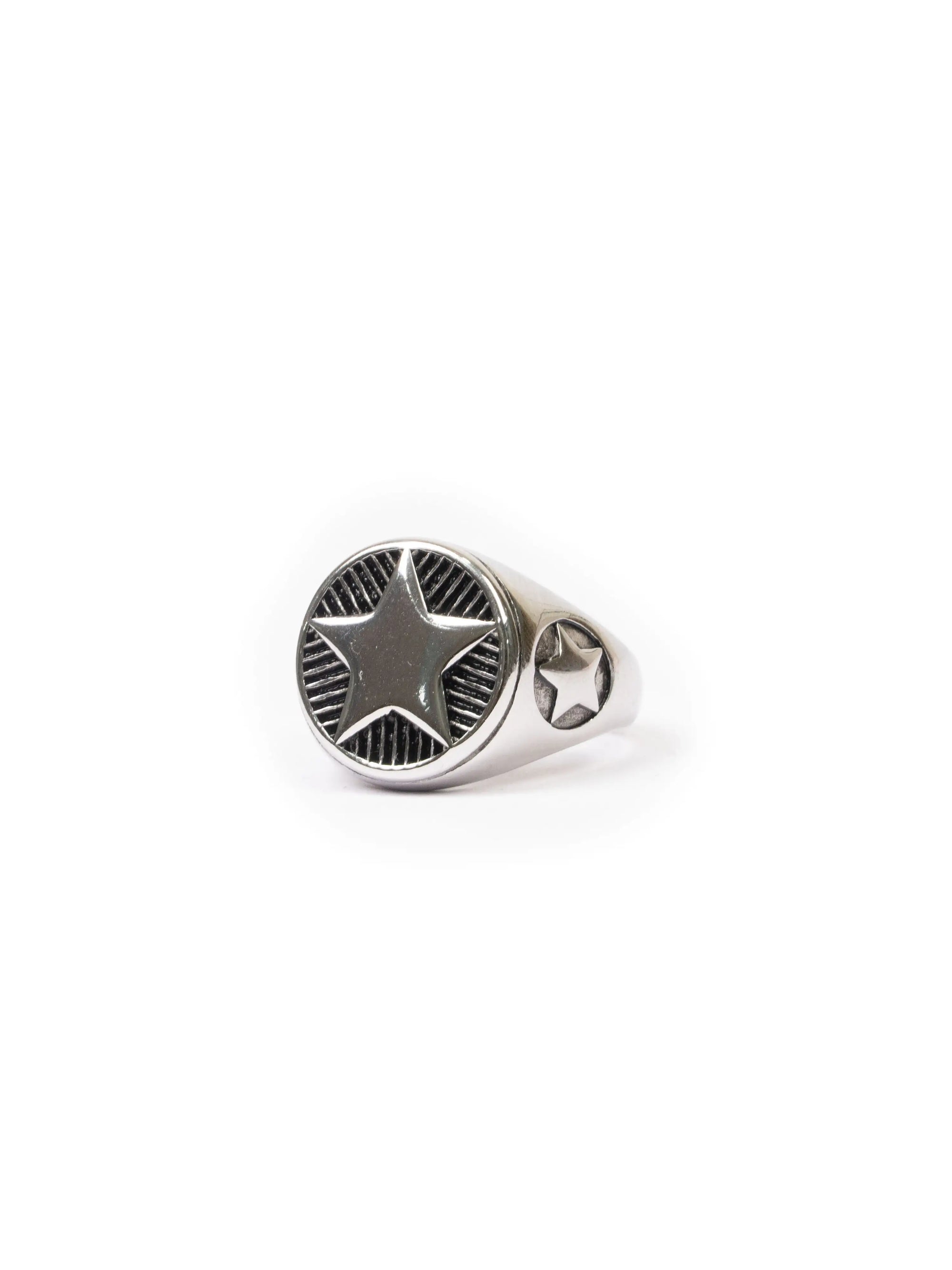 Silver ring with star design on a white background