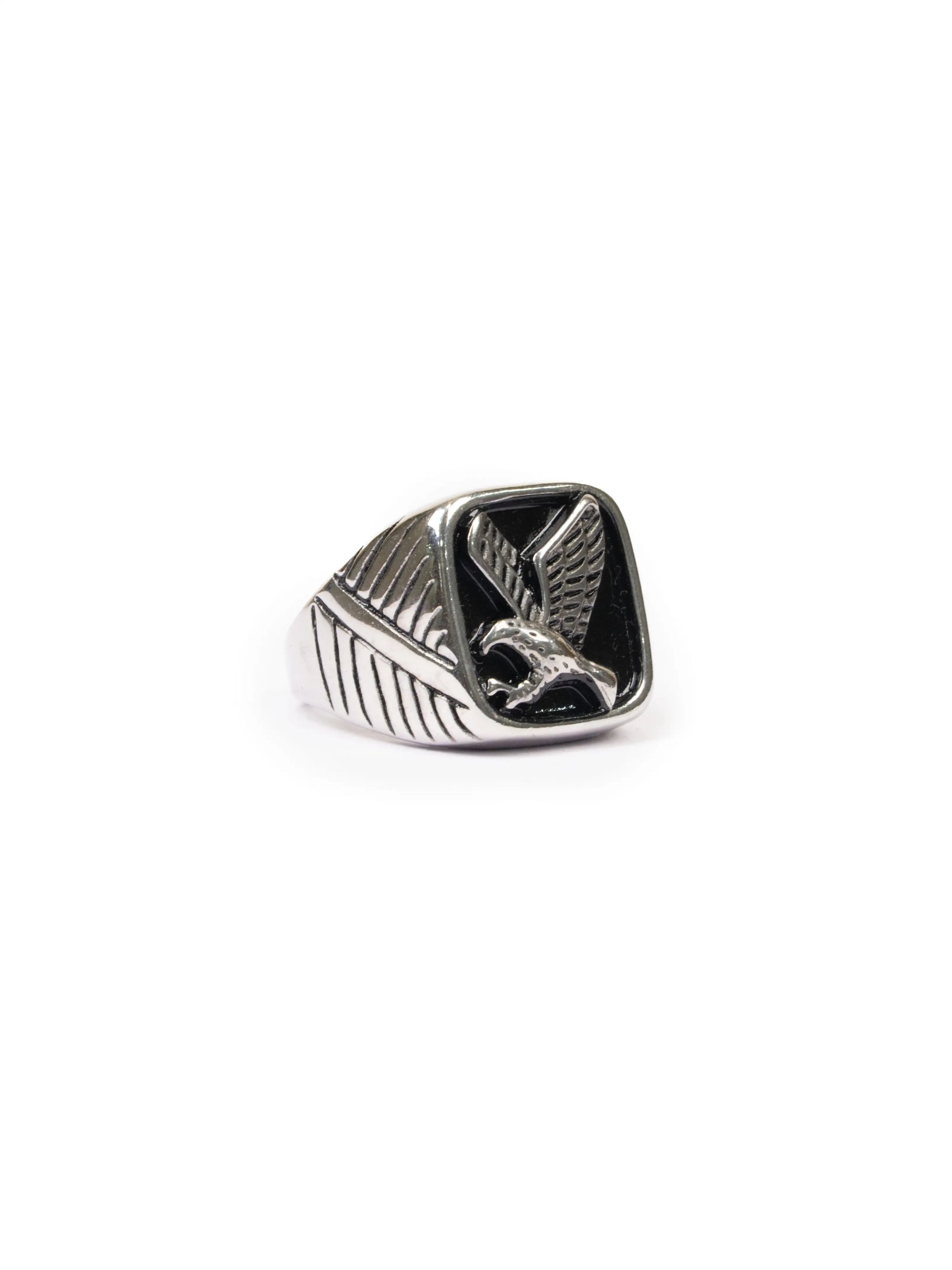 Silver ring with a eagle design on a white background