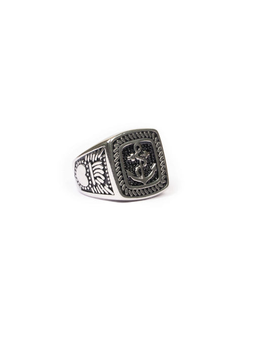 Silver ring with detailed design on a white background