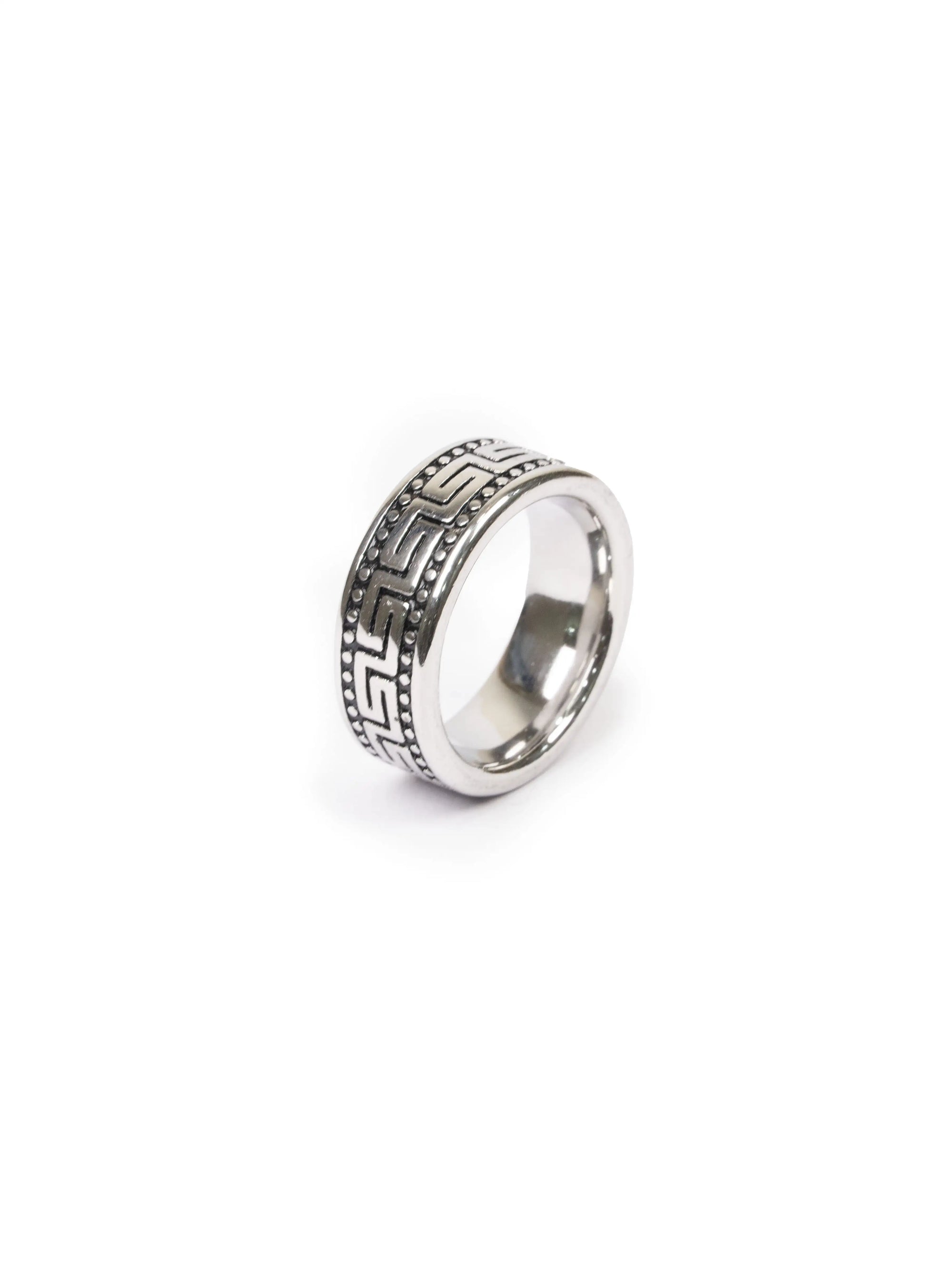 Silver ring with intricate design on a white background
